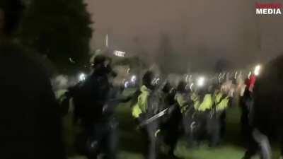 Huge amount of Police deployed to retake the Capitol grounds after launching a massive amount of tear gas to disperse the rioters. The crowds have subsequently thinned out.