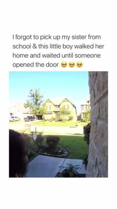 This boy walking a girl home from school and waiting till she enters the house