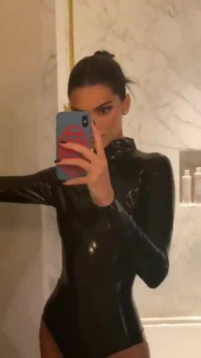 Wearing black latex costume