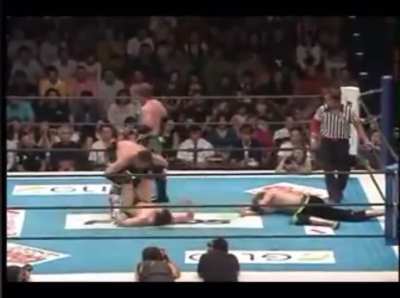 Finn Balor takin a brutal beating from Chris Saban and Alex Shelley while his tag partner Taguchi takes time to recover