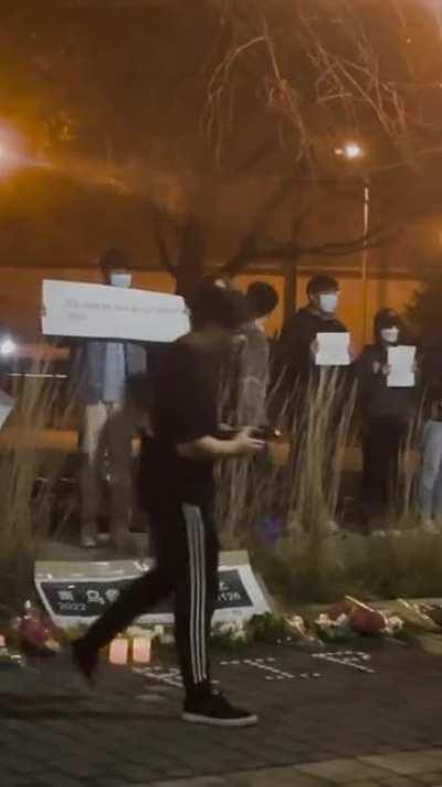 a snippet of the conflict at Urumqi fire vigil tonight