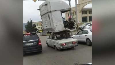 Tiny Car Carries Huge Lorry Cabin On ROOF