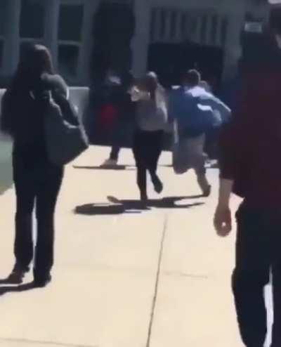Dude pretends to hide a gun near school and gets jumped