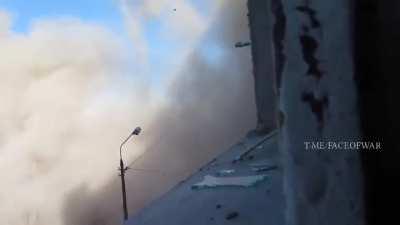 A tank fires in the direction of a cameraman during street battles in Borodianka