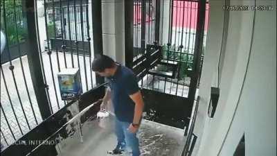 Man loses balance and ends up painting building entrance