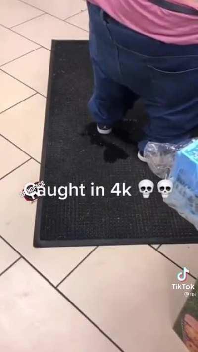 guy pisses himself as he checks out from a store