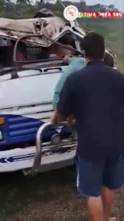 Immediate aftermath of truck crash, passenger was able to climb out of the truck but the driver was not able to without assistance