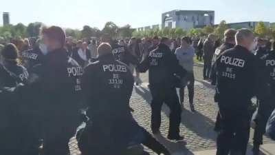 Anti-Lockdown Protester kicks sound assistant