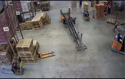 Dumbshit somehow manages to avoid being pancaked by his forklift.