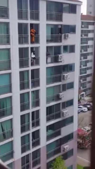 Firefighter dropkicks a woman in the face from the balcony above to prevent her suicide attempt