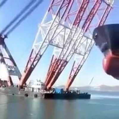 The world's largest floating crane holding a giant ship