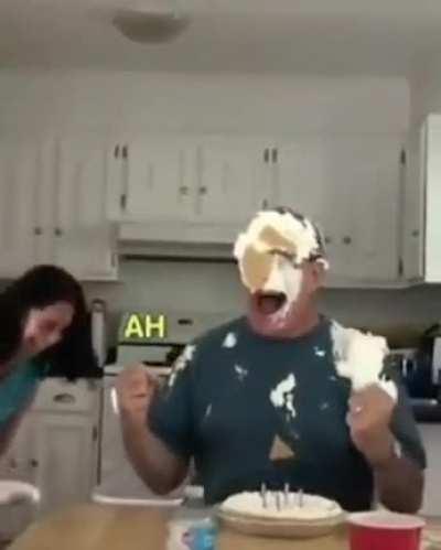 Man getting caked on his birthday.