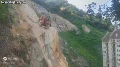 Excavator falls from cliff