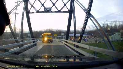 Idiot in a school bus. She’s waving for me to reverse