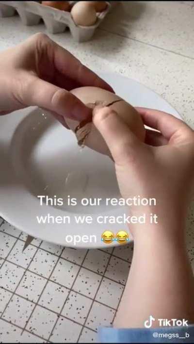 Cracking an egg open to find another egg