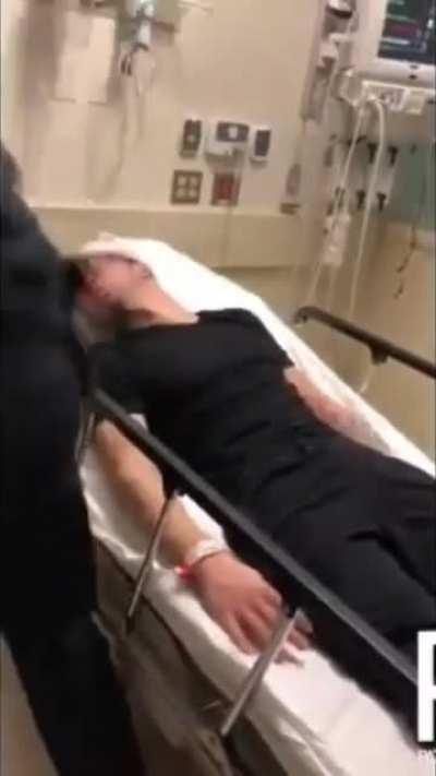 cop assaults man in hospital bed while partner films