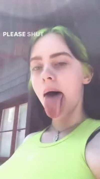 Billie Eilish showing of her long tongue