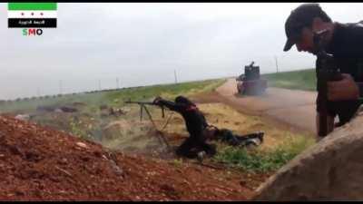 Opposition fighter lets off a sustained PKM burst towards SAA positions near Izraa, Syria - 2014