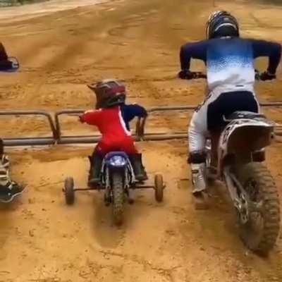 Little guy won't let training wheels slow him down (too much anyways)