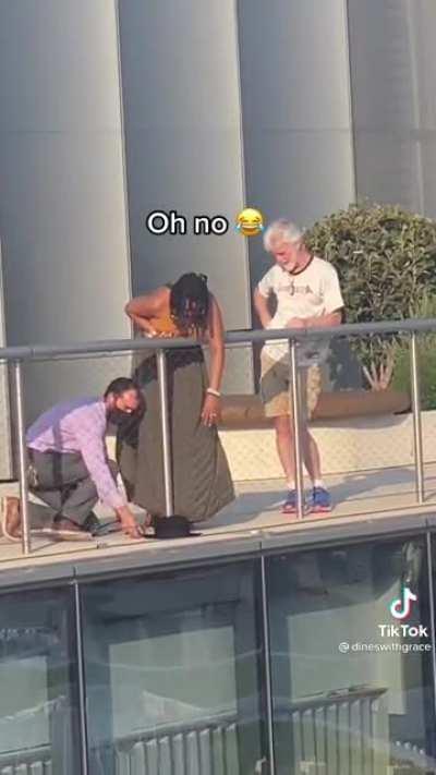 Woman tries to catch her hat