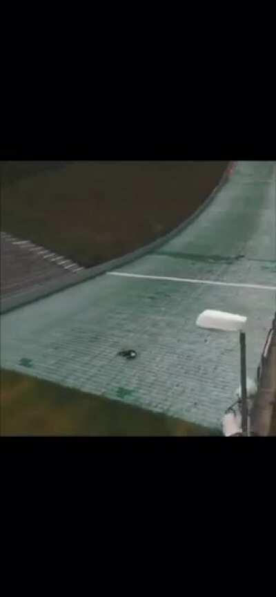 Riding a bike down a ski jump.