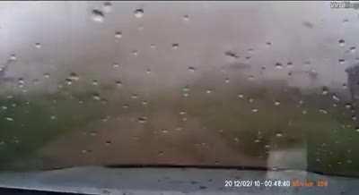 A driver pulls out of his garage, directly into a tornado.
