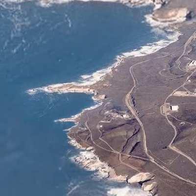 People on the beach waving at the satellite