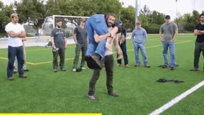 Army Ranger demonstrating how to pick up someone heavier than you