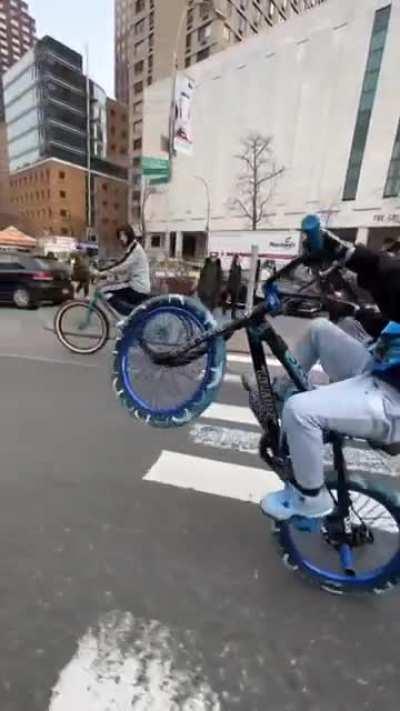 Perfect wheelie by a kid with a little inspiration from a wheelie master