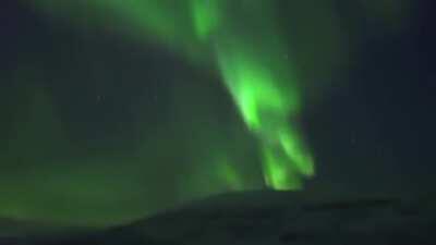 A lady showing what it's like to live in a place with the Northern Lights in your backyard