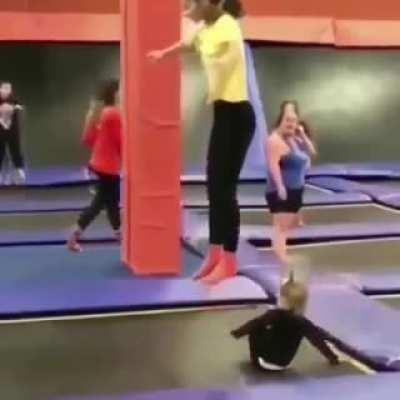 Kid walks onto a trampoline