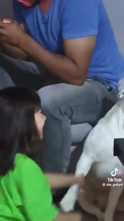 Filming while little girl is careless with their dog.