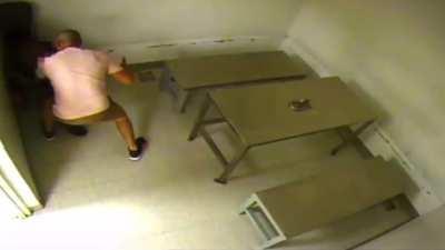 Dude beats the brakes off a cop during booking.