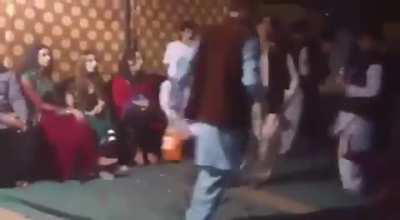 At a wedding in Pakistan. He is objecting to her public performance.