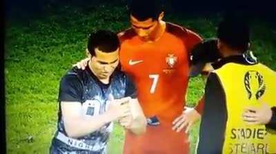 Cristiano Ronaldo waits for his fan's phone to work