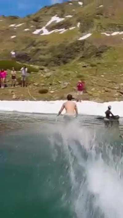 Skier sliding over lake's surface using momentum