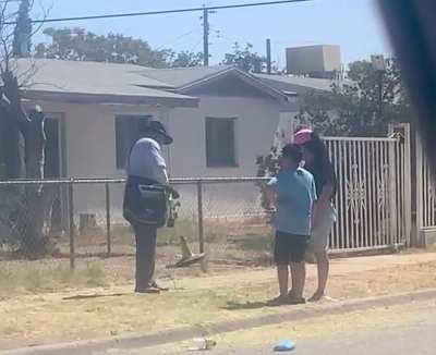 El Paso Postman taking time on a hot morning to fix trimmer and show young mom how to use it