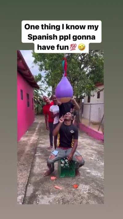 Trying not to get wet while popping ballons