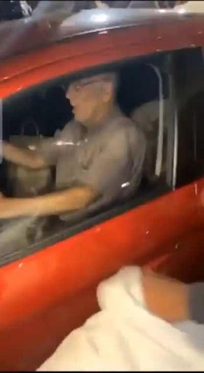 Chicagoans mob the car of an elderly motorist...