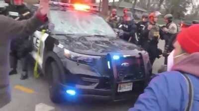 Picking up a large block of cement in front of a cop