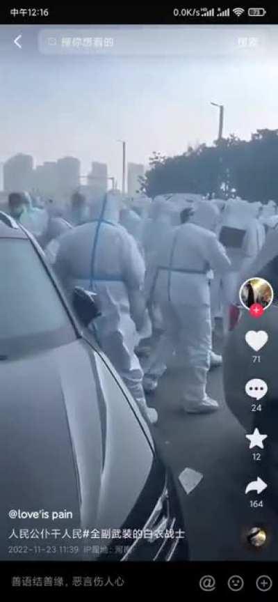 Police wearing protective suits beat rioters causing severe injuries