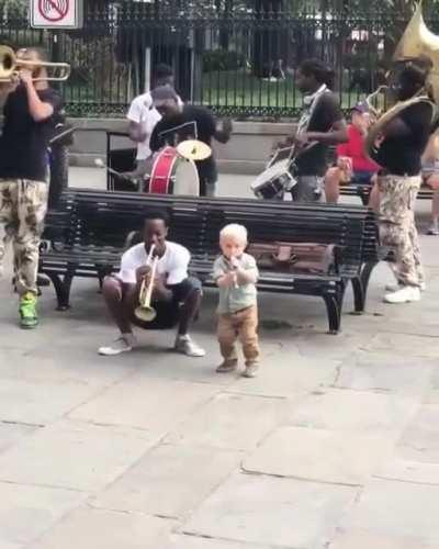 Little kid plays his heart out with street musicians