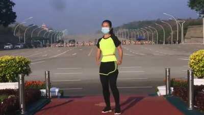 This woman from myanmar was recording her aerobics class. unbeknownst to her, she records the military junta arriving to the parliament for a coup d'etat in the background..