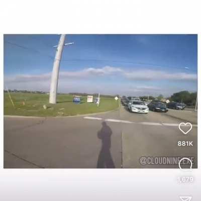 Car almost flips on motorcyclist
