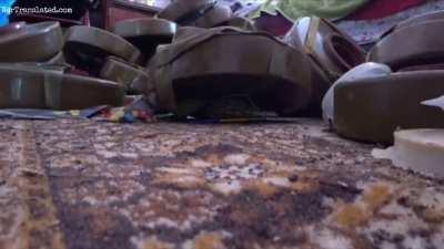 Ukrainian soldier demonstrates defusing a grenade placed under a mine in a residential building.