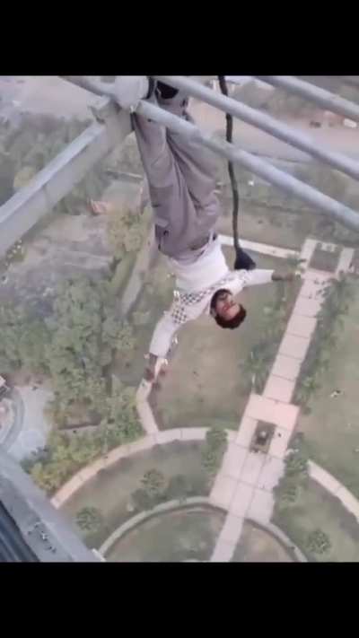 Guy performing stunts on a tall tower