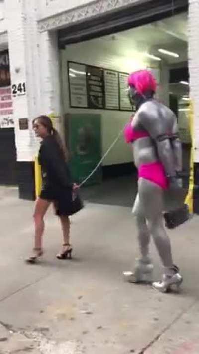 A woman walking her pet(?)