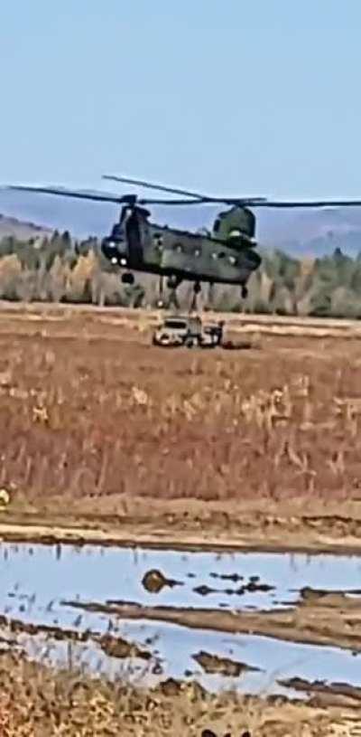 A chinook dropping a G-Wagon with a trailer.