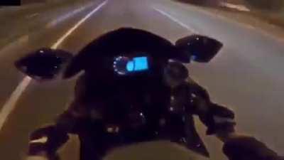 Motorcyclist races car and ends up crashing on the highway