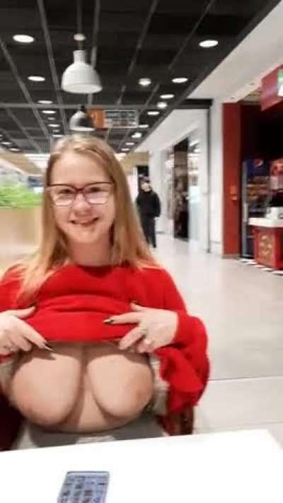 In a shopping mall - normally, as in such places, stores, restaurants, cinema, people are hanging around - not sure what for. I know why I'm there. I show my huge boobs. Heh
